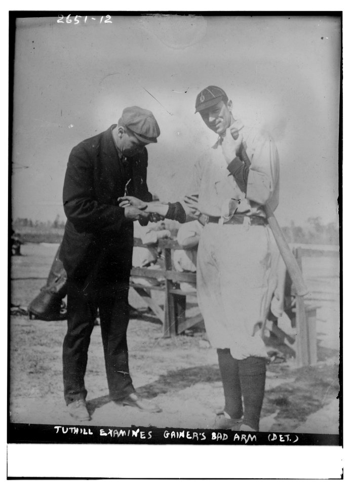 Harry Tuthill, Detroit Tigers trainer, examines bad arm of Del Gainer, first baseman, Detroit AL (baseball) LCCN2014692676