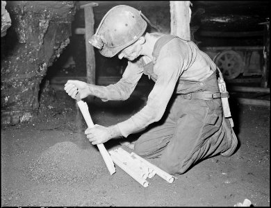 Harry Fain, coal loader, makes stemmings which are used in proper placing of powder charge. Inland Steel Company... - NARA - 541473 photo