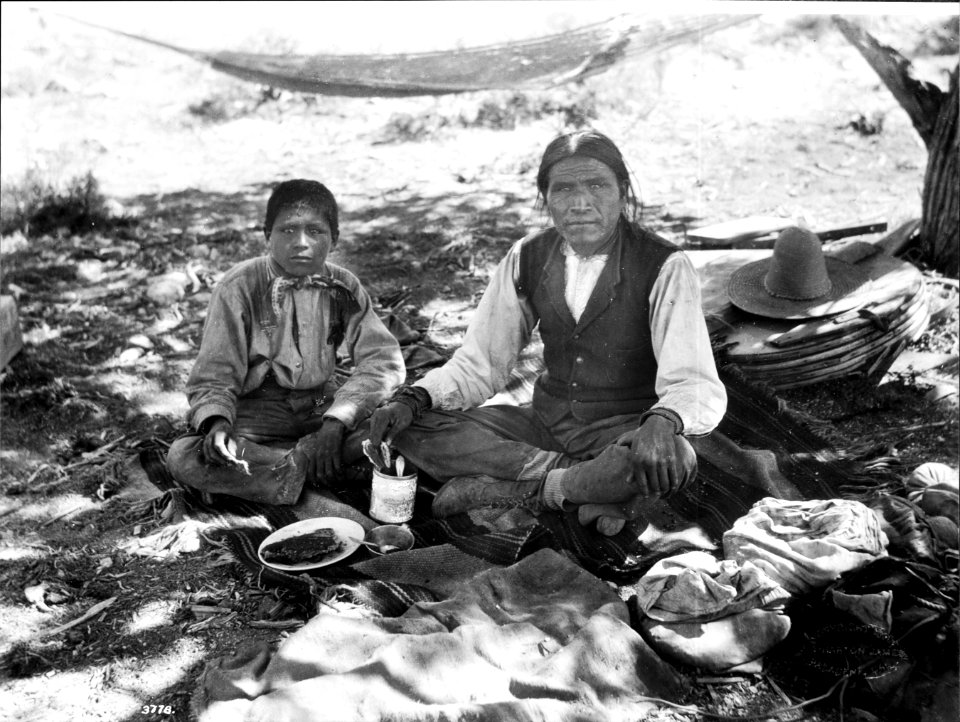 Havasupai Indian boy with his father, Vesna, eating lunch during a walking trip, ca.1899 (CHS-3778)