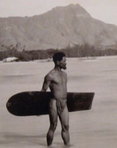 Hawaiian with surfboard and Diamond Head in the background (cropped) photo