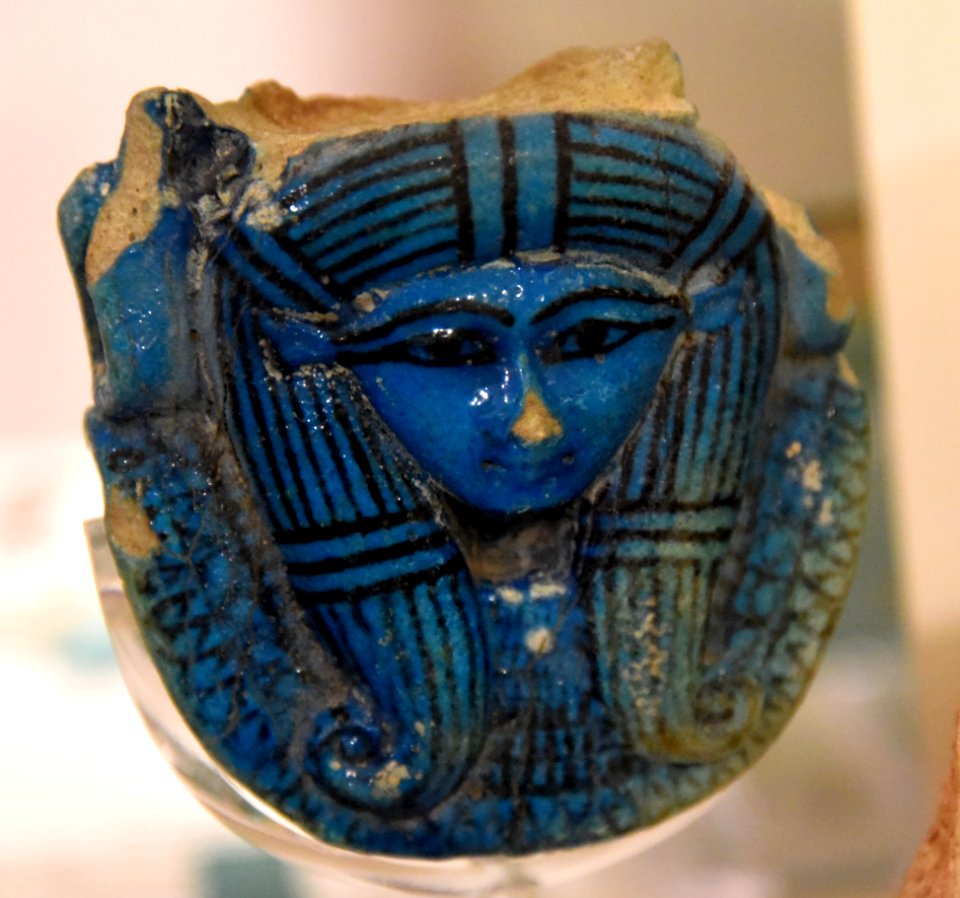Hathor's head. Faience, from a sistrum's handle. 18th Dynasty. From Thebes, Egypt. The Petrie Museum of Egyptian Archaeology, London