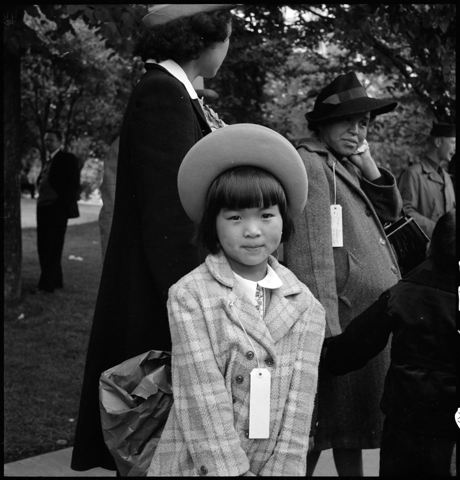 Hayward, California. A young member of an evacuee family awaiting evacuation bus. Evacuees of Jap . . . - NARA - 537509
