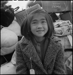 Hayward, California. A young member of an evacuee family awaiting evacuation bus. Evacuees of Japa . . . - NARA - 537510 photo