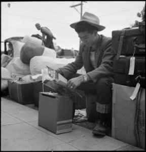 Hayward, California. Eddie Nomura, president of the senior class in the Hayward High School, reads . . . - NARA - 537517