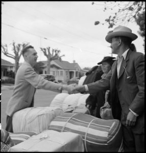 Hayward, California. Friends say good-bye as family of Japanese ancestry await evacuation bus. Bag . . . - NARA - 537514