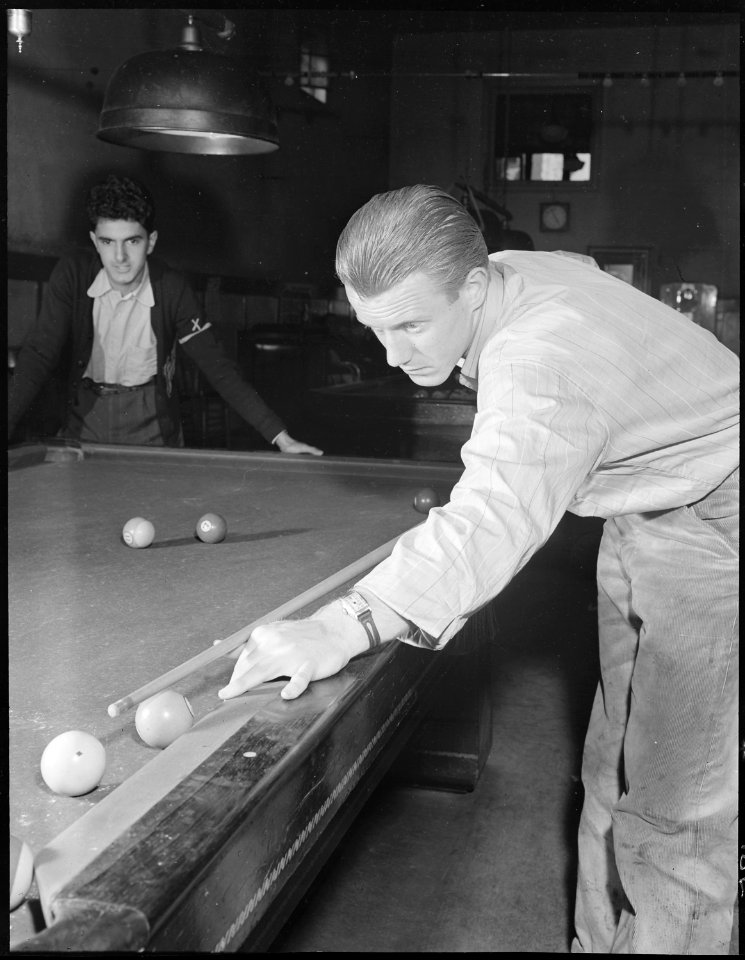 Hayward, California. Pool Recreation. Ten minutes to four by the wrist watch of this high school boy with the cue. In... - NARA - 532240