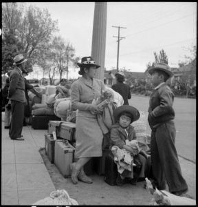 Hayward, California. With baggage piled on sidewalk, evacuees of Japanese ancestry await evacuation . . . - NARA - 537523