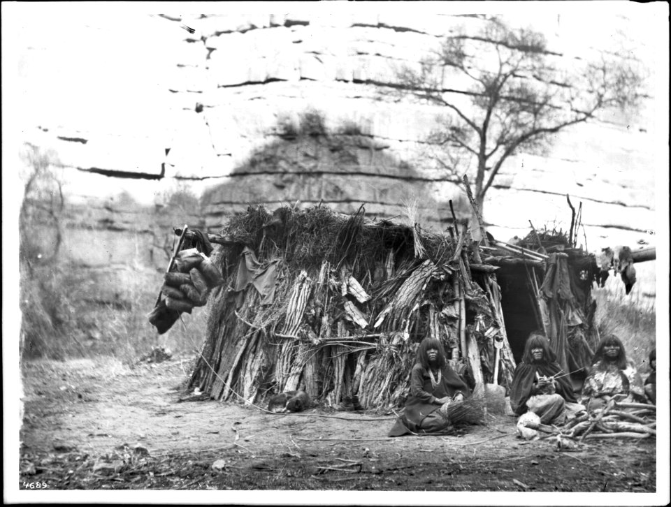 Havasupai women making baskets in front of a dwelling in Havasu or Cataract Canyon, ca.1900 (CHS-4689)