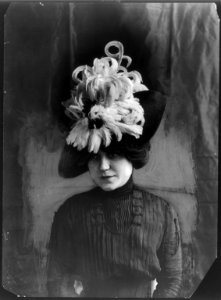 Head and shoulders of model wearing Chanticleer hat of bird feathers LCCN2005691560