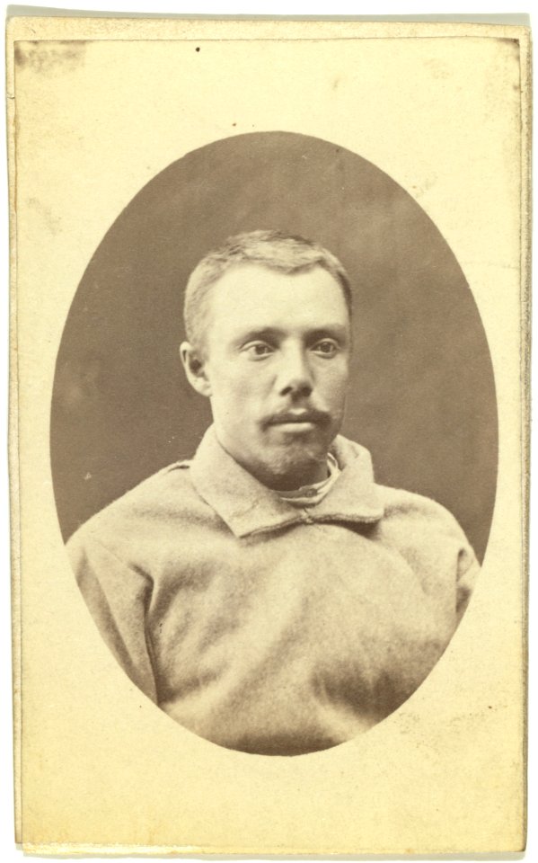 Head-and-shoulders portrait of a man, dressed in convict clothing, facing slightly right LCCN99615644