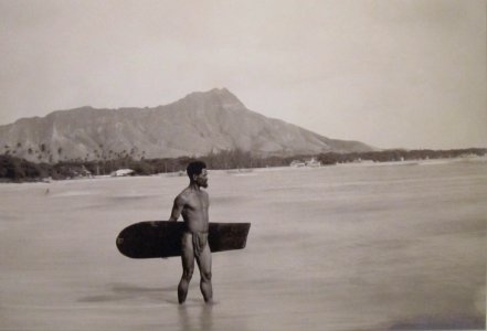 Hawaiian with surfboard and Diamond Head in the background photo
