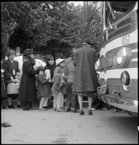 Hayward, California. Farm families of Japanese ancestry are being checked into the evacuation buses . . . - NARA - 537521 photo