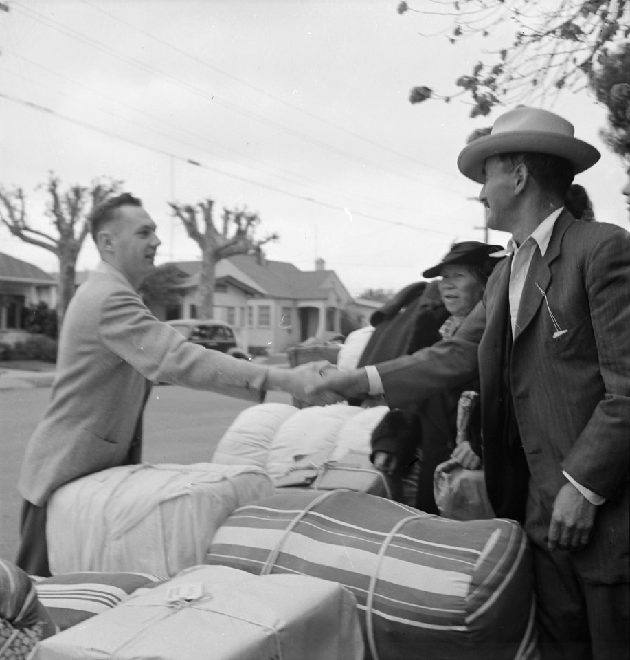 Hayward, California. Friends say good-bye as family of Japanese ancestry await evacuation bus. Bag . . . - NARA - 537514 (cropped)