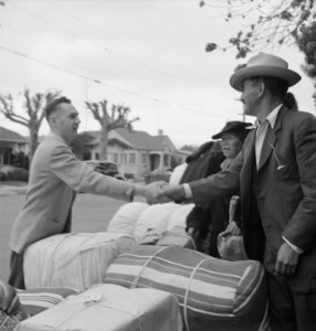 Hayward, California. Friends say good-bye as family of Japanese ancestry await evacuation bus. Bag . . . - NARA - 537514 (cropped) photo