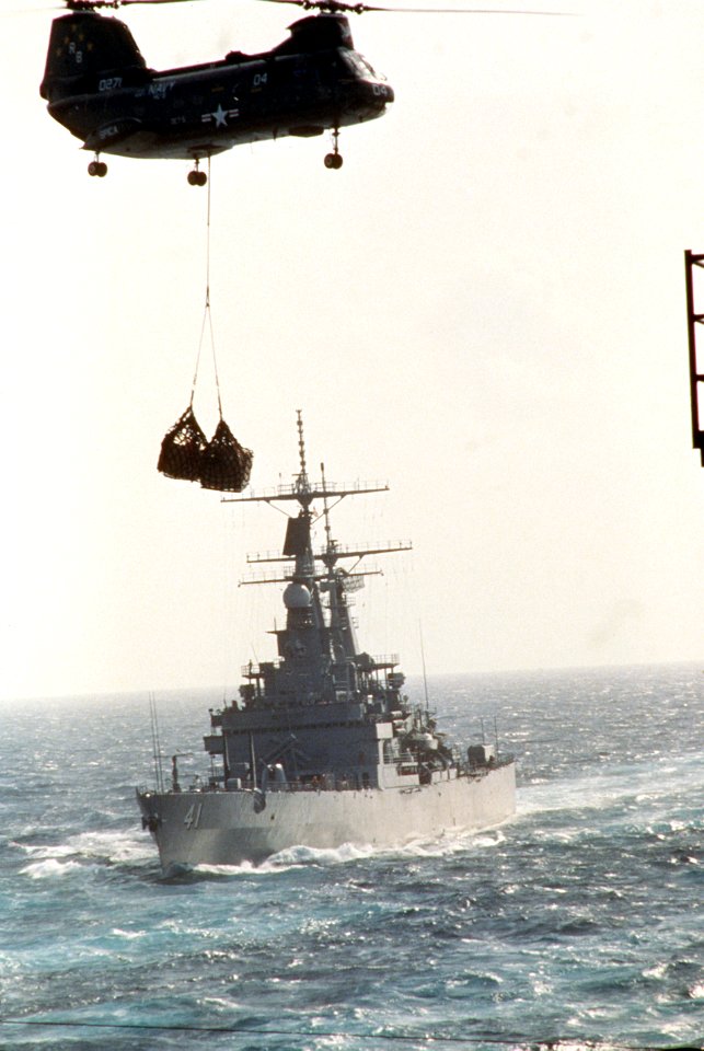 HC-5 CH-46 helihoisting cargo during vertical replenishment flying past USS Arkansas (CGN-41) US Navy 330-CFD-DN-ST-86-11414