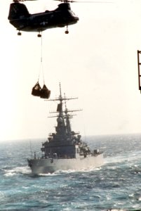 HC-5 CH-46 helihoisting cargo during vertical replenishment flying past USS Arkansas (CGN-41) US Navy 330-CFD-DN-ST-86-11414