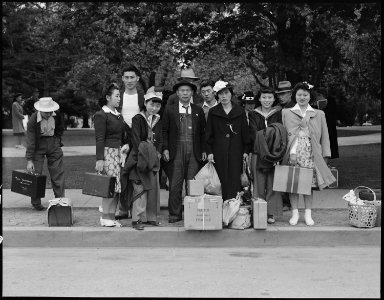 Hayward, California. This farm family await evacuation bus. Father and mother immigrated from Japa . . . - NARA - 537508 photo