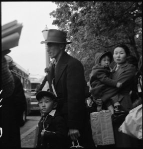 Hayward, California. This farm family of Japanese ancestry to board the evacuation bus which is app . . . - NARA - 537516 photo
