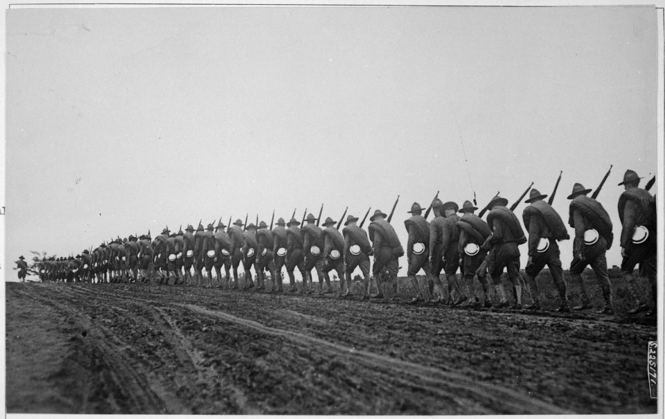 Headquarters Troop of the 27th Division, New York National Guard, silhouetted against the gathering dusk as they... - NARA - 533682 photo