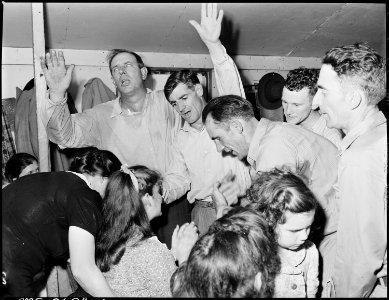 Healing laying on of hands ceremony in the Pentecostal Church of God. Lejunior, Harlan County, Kentucky. - NARA - 541338
