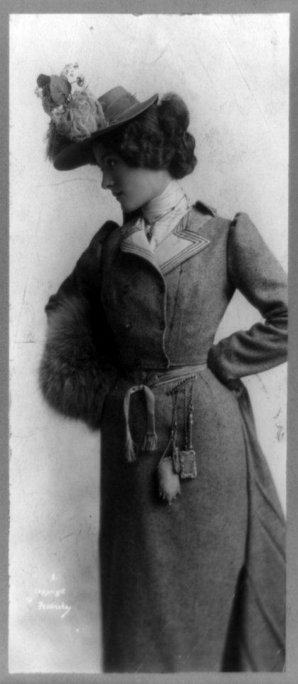 Helen B. Garrettson, portrait, facing left, standing with hands on hips LCCN91481437