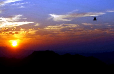 Helicopter flying over mountains of Afghanistan in 2002 photo