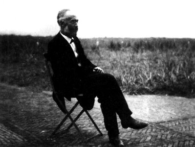Hendrik Antoon Lorentz sitting on a chair in the open air, about 1900