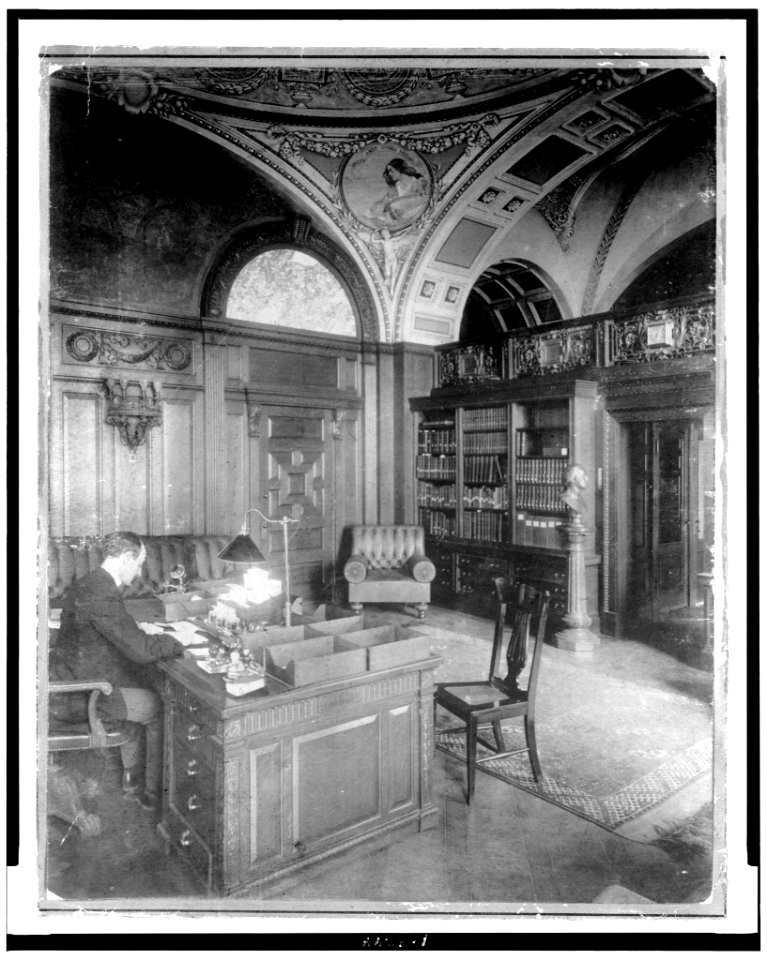 Herbert Putnam, full-length portrait, seated, facing right, in his office, Library of Congress LCCN93509713