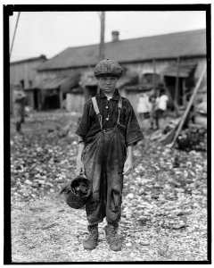 Henry, 10 year old oyster shucker who does five pots of oyster (sic) a day. Works before school, after school, and Saturdays. Been working three years. Maggioni Canning Co. LOC nclc.05334 photo