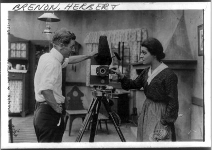 Herbert Brenon & Alla Nazimova examining a movie camera, Aug. 9, 1916 - half-length, standing, right profile LCCN2005679802
