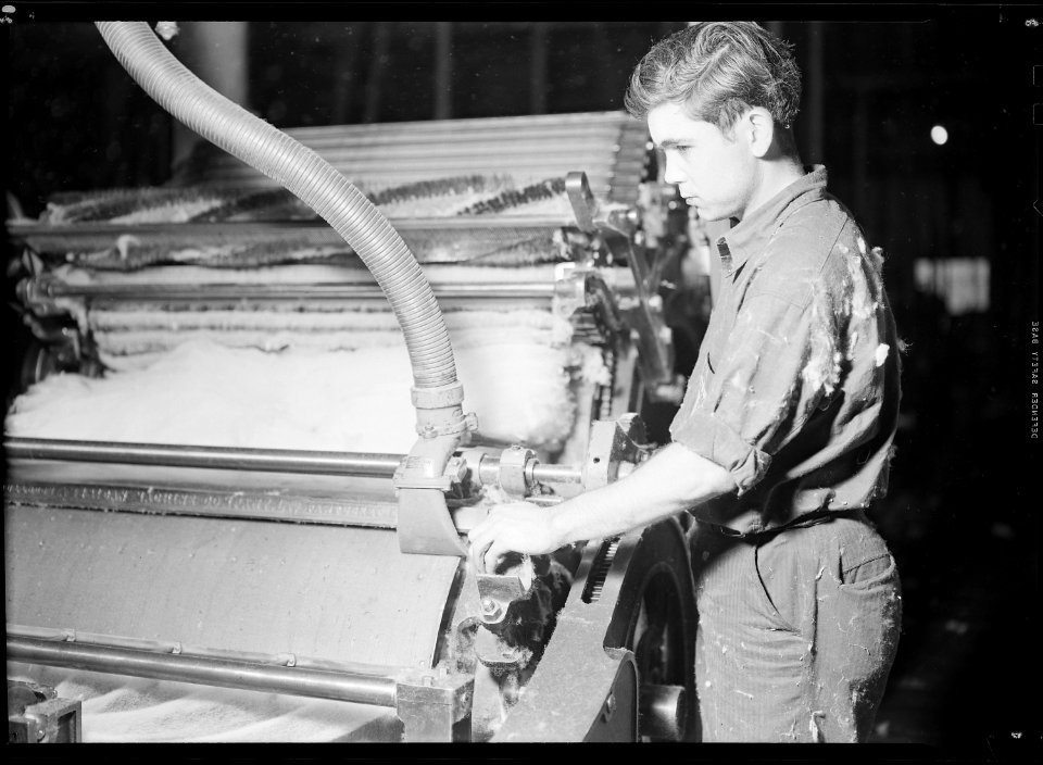 High Point, North Carolina - Textiles. Pickett Yarn Mill. Cards - starting card in motion, showing man and part of... - NARA - 518503