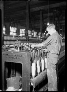 High Point, North Carolina - Textiles. Pickett Yarn Mill. Intermediate frame - highly skilled - man at machine in... - NARA - 518509