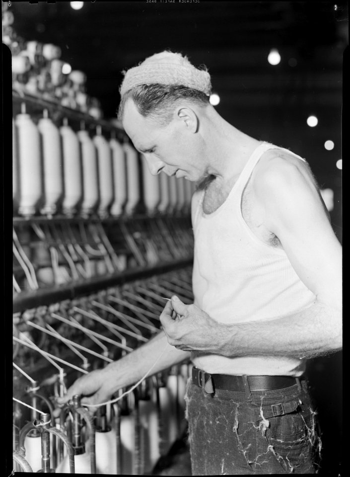 High Point, North Carolina - Textiles. Pickett Yarn Mill. Slubber - semi-skilled - man at machine in normal position - NARA - 518508