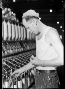 High Point, North Carolina - Textiles. Pickett Yarn Mill. Slubber - semi-skilled - man at machine in normal position - NARA - 518508