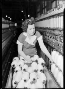 High Point, North Carolina - Textiles. Pickett Yarn Mill. Speeder - frame hand doffing spools off speeder - highly... - NARA - 518511