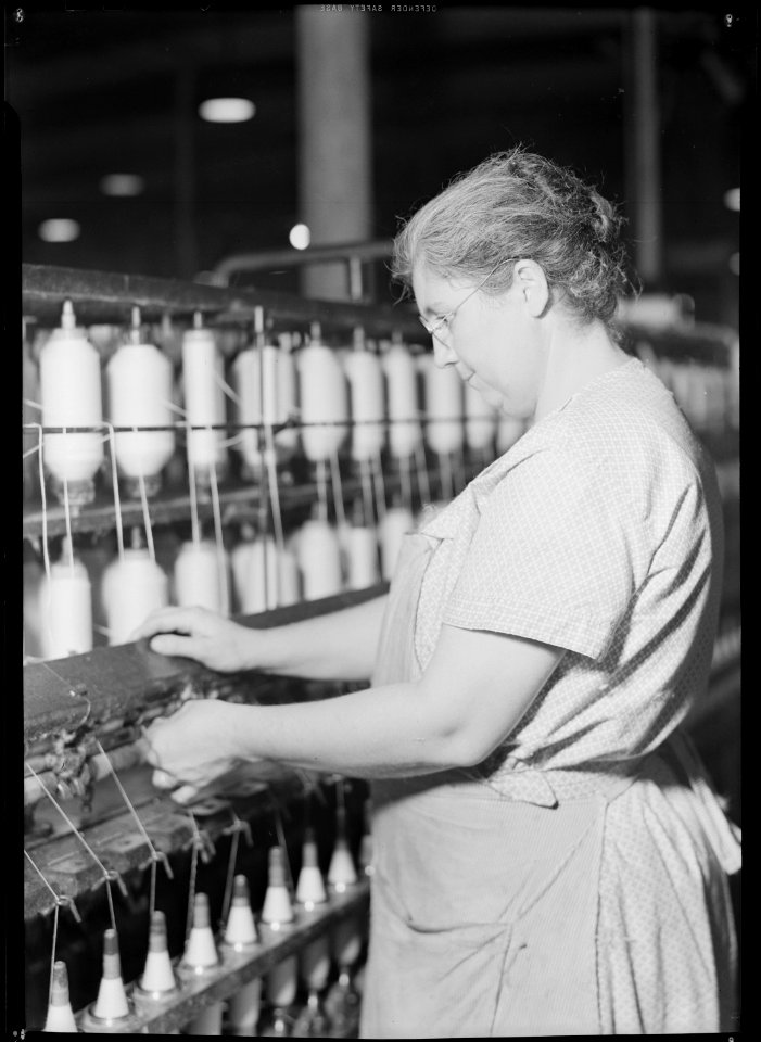 High Point, North Carolina - Textiles. Pickett Yarn Mill. Spinning frame - H & B frame - highly skilled operator... - NARA - 518512