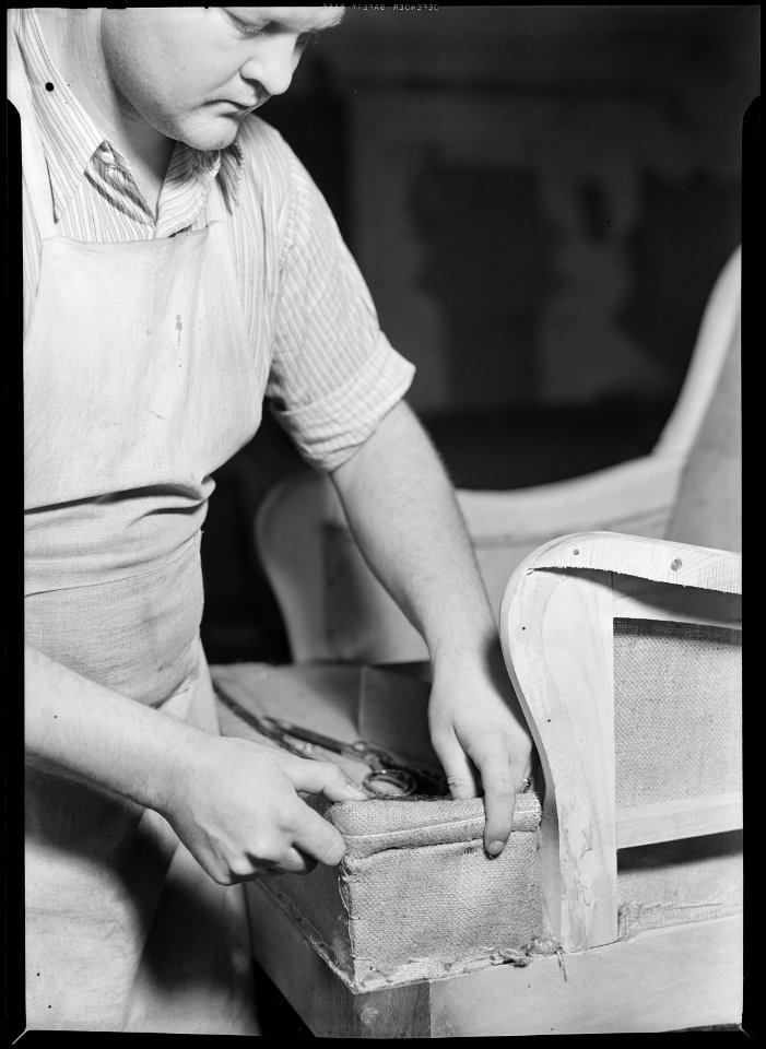 High Point, North Carolina - Upholstering. Tomlinson Chair Manufacturing Co. Applying edge to chair - ready sewed... - NARA - 518482