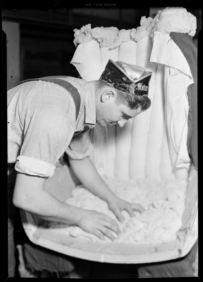 High Point, North Carolina - Upholstering. Tomlinson Chair Manufacturing Co. Applying filling to a channel back chair. - NARA - 518480