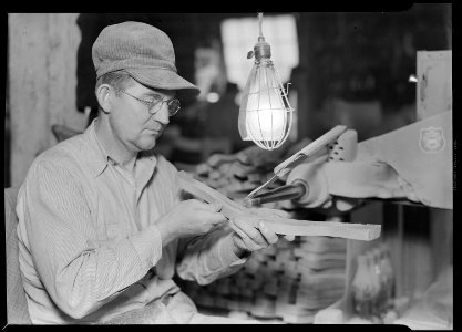 High Point, North Carolina - Upholstering. Tomlinson Chair Manufacturing Co. Spindle carver - top-back of chair in... - NARA - 518487