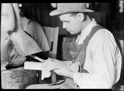 High Point, North Carolina - Upholstering. Tomlinson Chair Manufacturing Co. Spindle sander - chair leg - showing man... - NARA - 518496