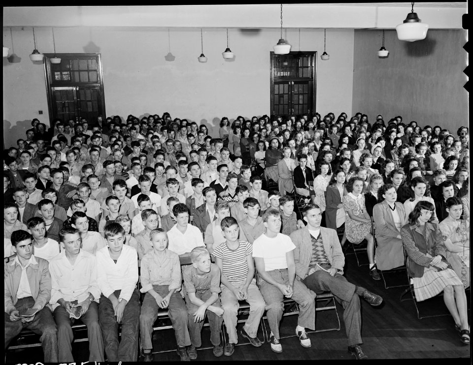 High school students in auditorium. School is adjacent to property of Inland Steel Company, and serves the children... - NARA - 541512