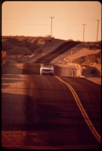 Highway-through-desert-near-colorado-river-road-is-constructed-in-a-series-of-dips-as-a-protection-against-flash-flooding-may-1972 7152645375 o