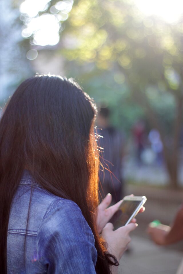 Girl calling long hair woman smart phone