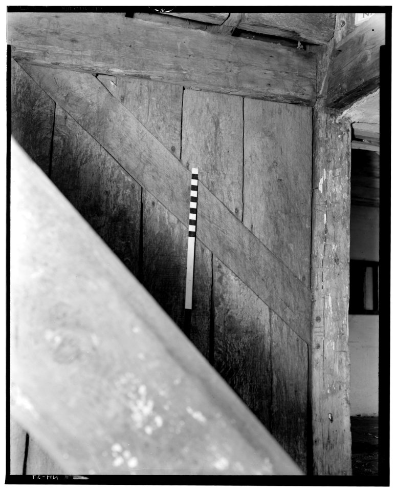 Historic American Buildings Survey L. C. Durette, Photographer REAR STAIRS 1st. TO 2nd. FLOOR SHOWING POST OF CHIMNEY GIRT and OVERHANG - Doe Garrison, Lamprey River and Great Bay, HABS NH,8-NEWM,1-20