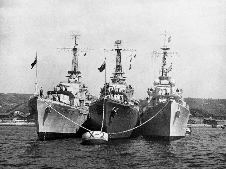 HMAS Warramunga (D123), HMCS Nootka (DDE 213) and HMS Cockade (D34) at anchor, in 1951 (NH 97046)