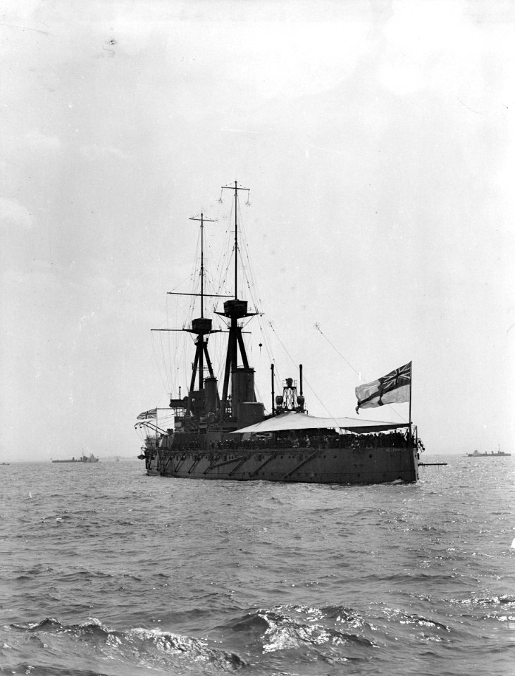 HMS 'Bellerophon' (1907) with awning rigged aft, anchored in the Thames Estuary. RMG P00031
