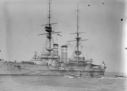 HMS 'Queen' (1902) with awning rigged aft, anchored at Spithead. RMG P00034 photo