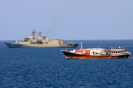 HMAS Anzac (FFH 150) is underway alongside a dhow in the Gulf of Aden.