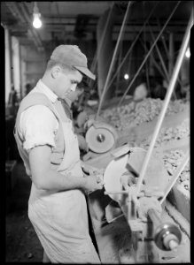 Holyoke, Massachusetts - Paragon Rubber Co. and American Character Doll. Buffing rubber doll bodies. - NARA - 518348
