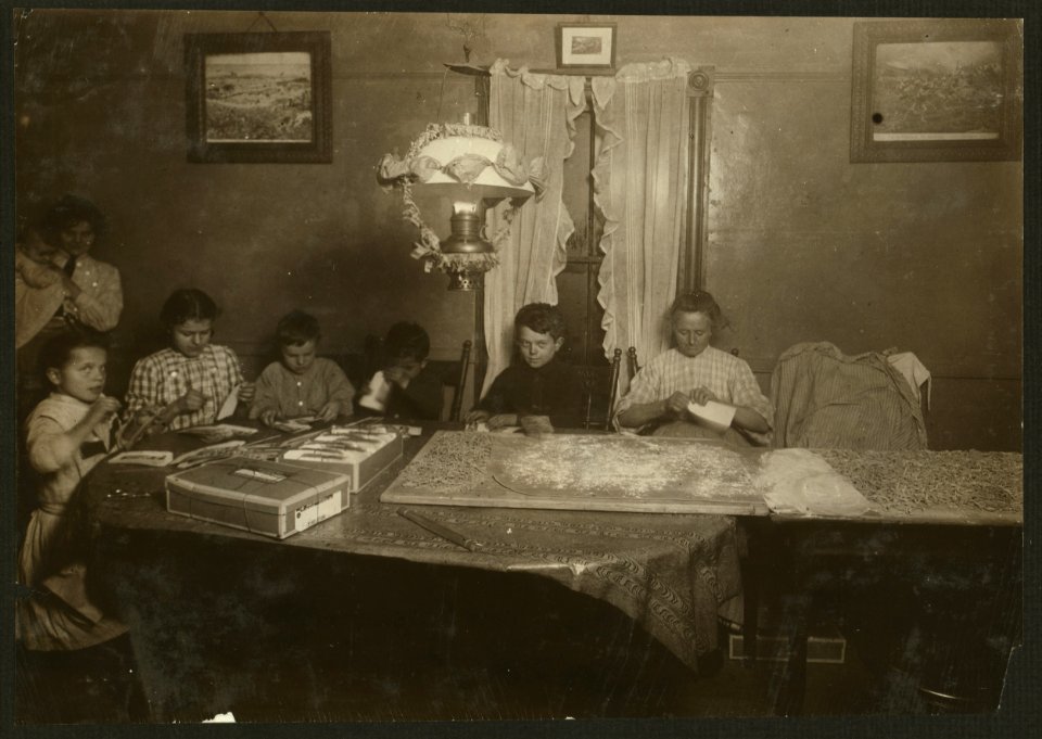 Home of Desiderio Cella, 11 Coburn Street, So. Framingham, Mass. Children - 13, 12, 10, 8, 7 years old working on tags in dirty room with macaroni all spread out on table being cut. Tag LOC nclc.04287